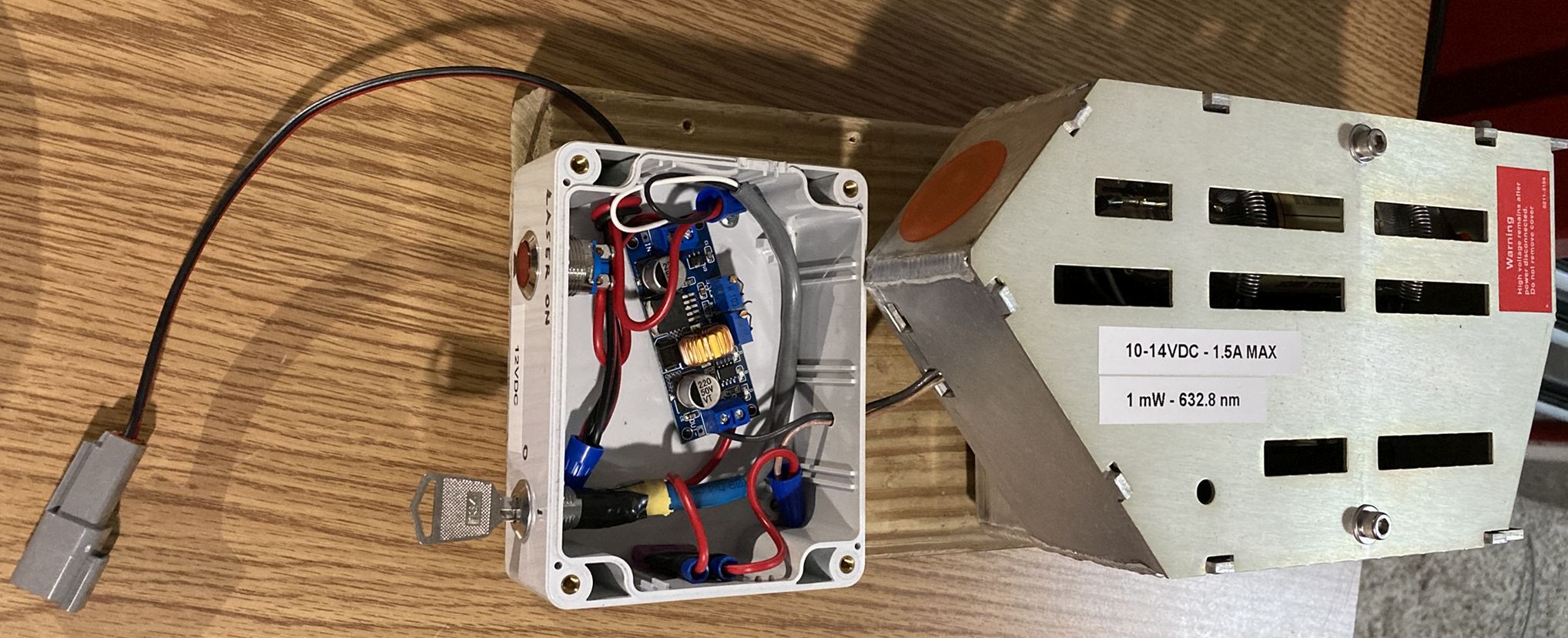 red HeNe laser system with tube in cage and power supply